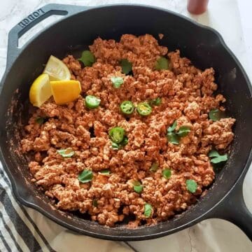Tofu Sofritas with Chipotle Adobo sauce served with garnishes.