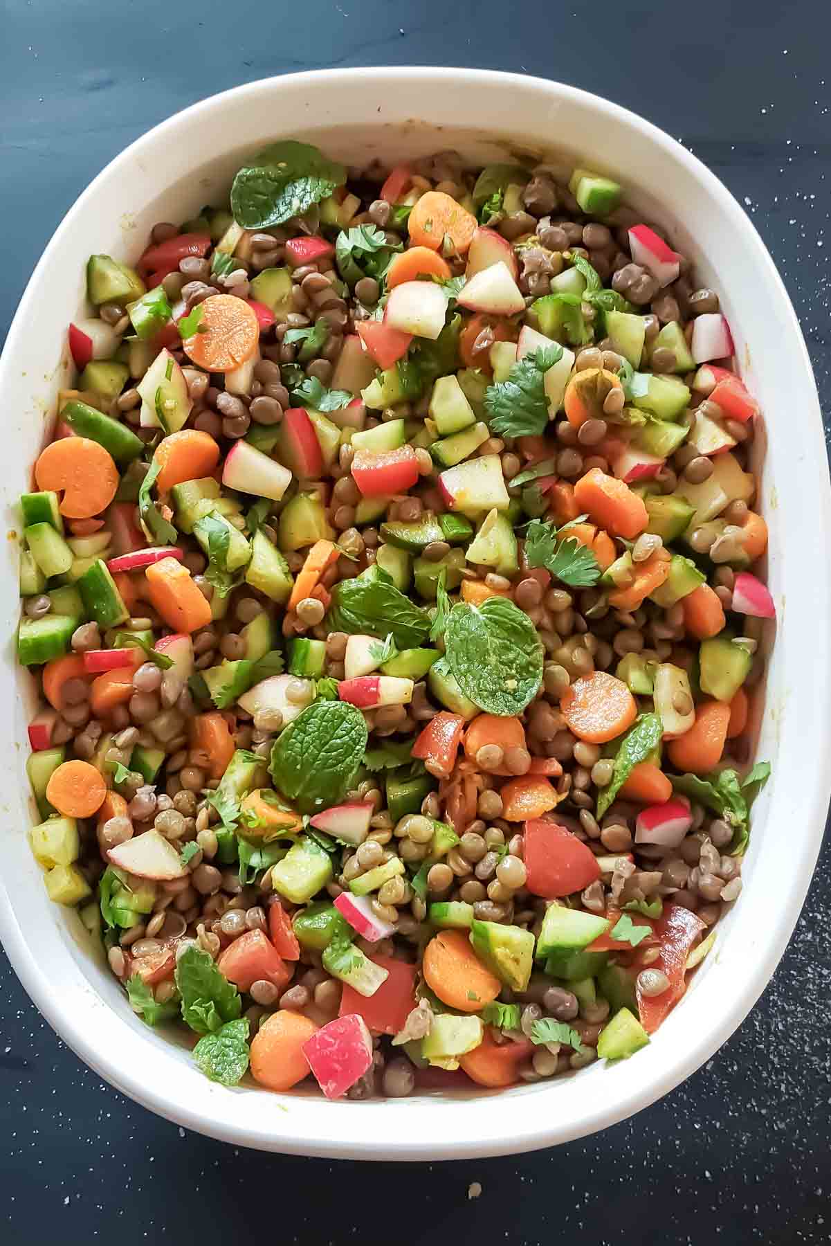A bowl full of Curry Lentil Salad made with cooked lentils and curry lemon dressing. This vegan Indian Lentil Salad is full of plant protein and super flavorful. 