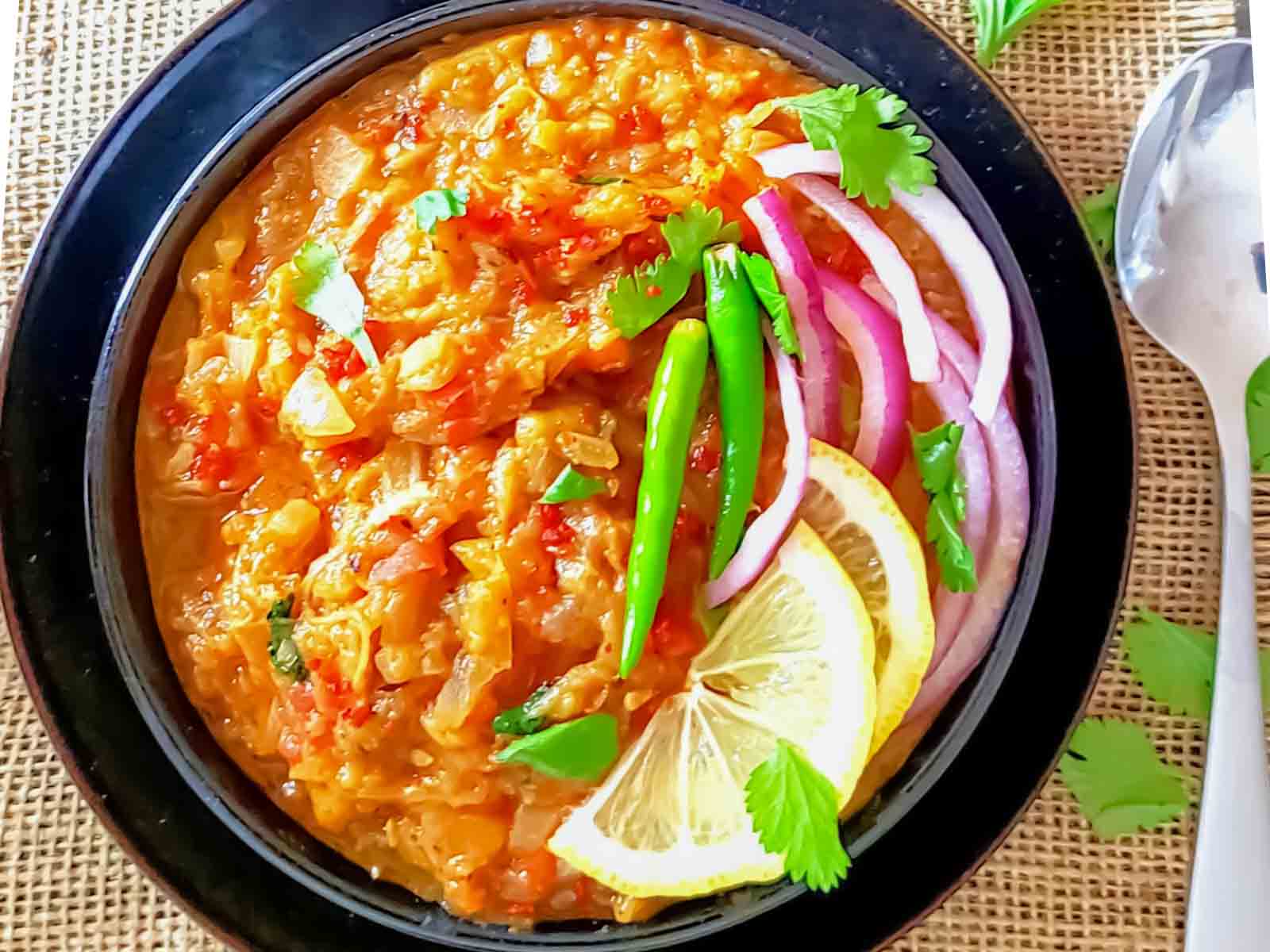 Delicious baingan bharta  which is spiced eggplant mash served with garnishes.