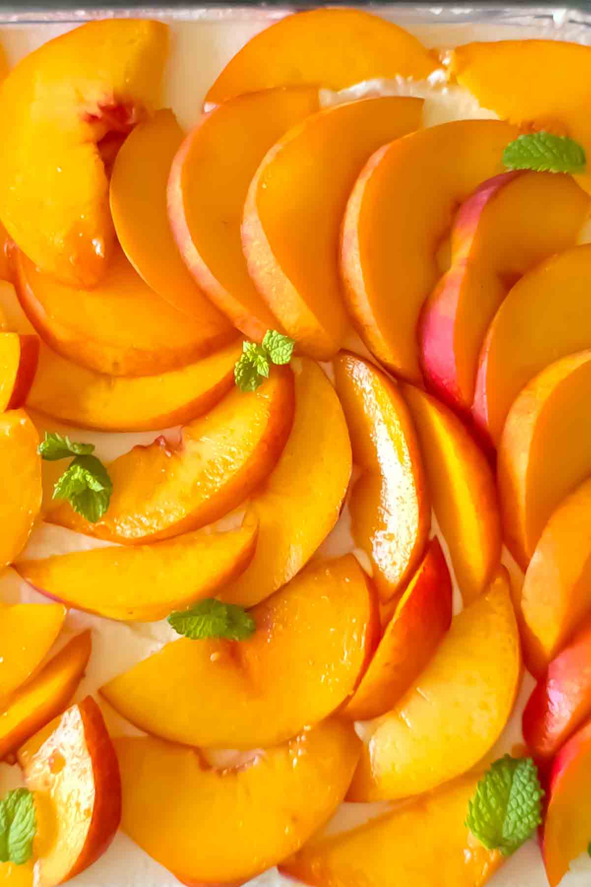 Creamy homemade peach cheesecake with graham cracker crust.