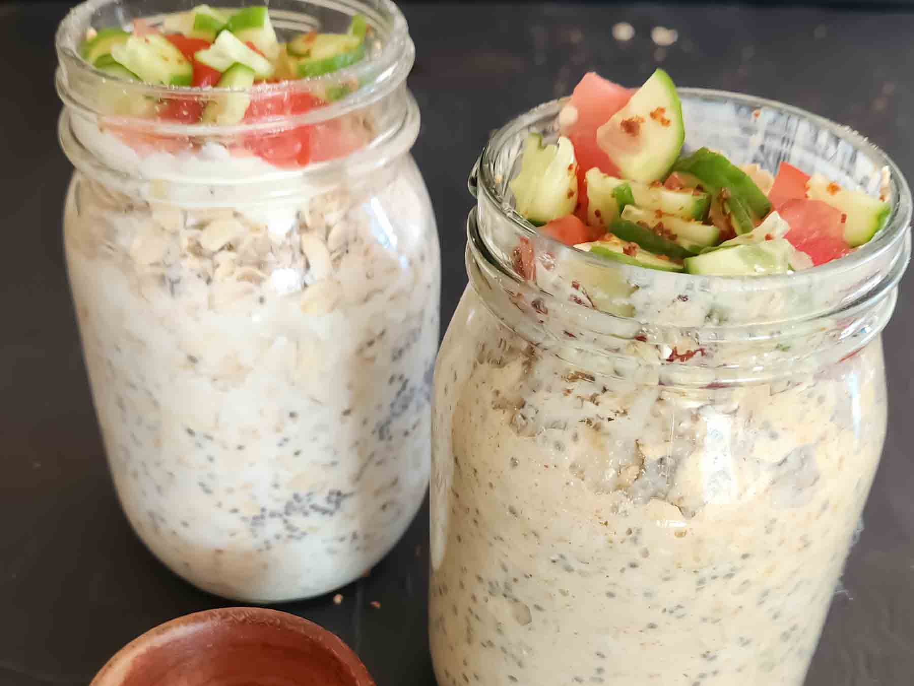 Savory oats topped with fresh vegetables and seeds.