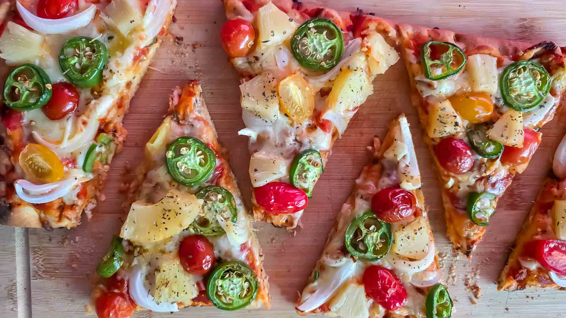 Crispy flatbread pizza with pineapple, jalapeños, mozzarella cheese, and fresh basil.