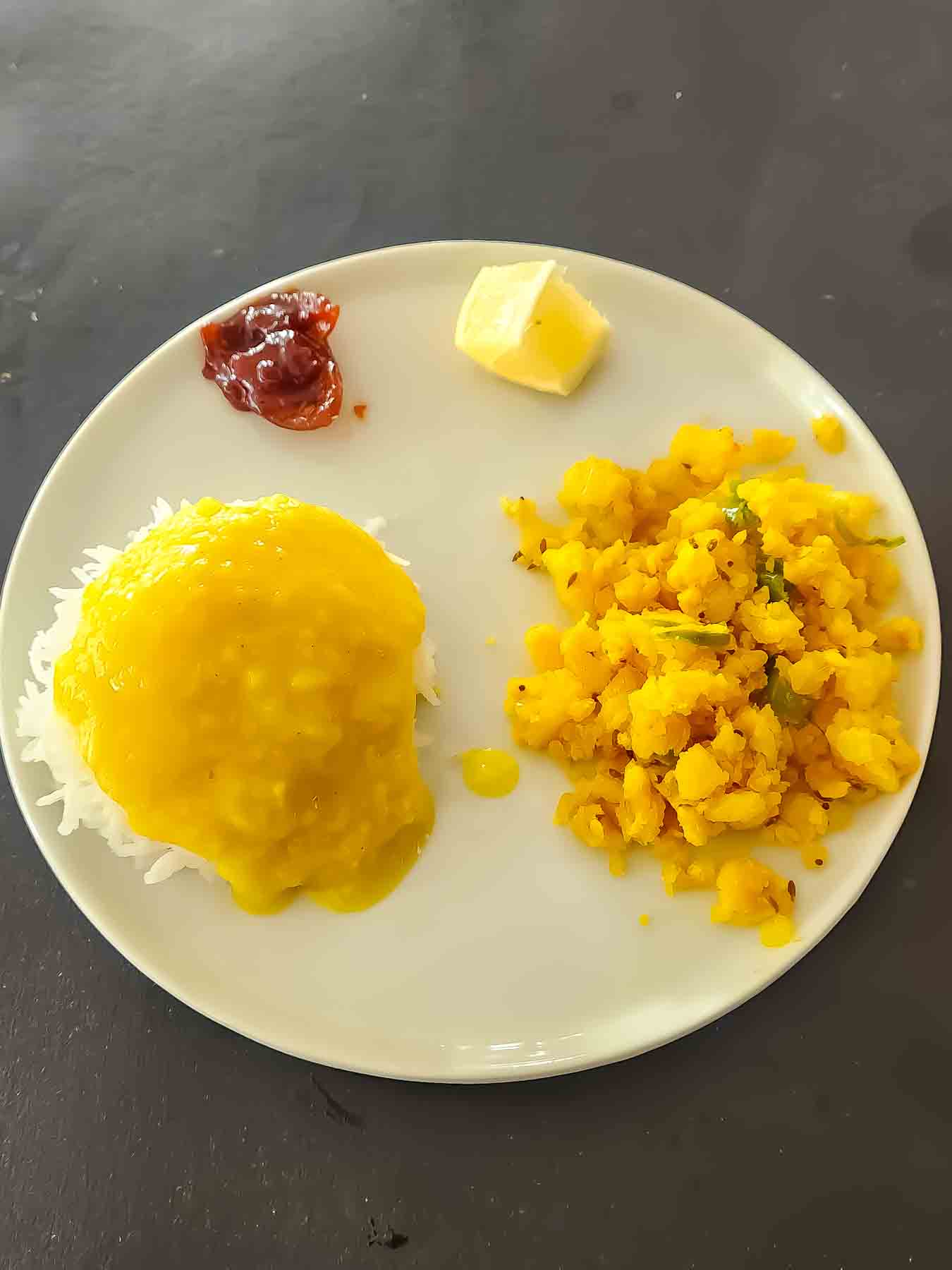 Bata bhaji-potato masala served with varan bhat for authentic Maharashtrian dinner.