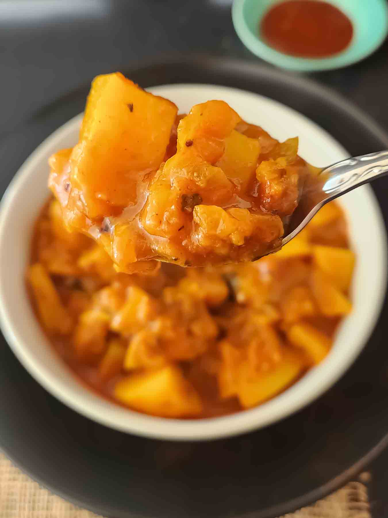 Bowl of vegan vegetable vindaloo with potatoes.