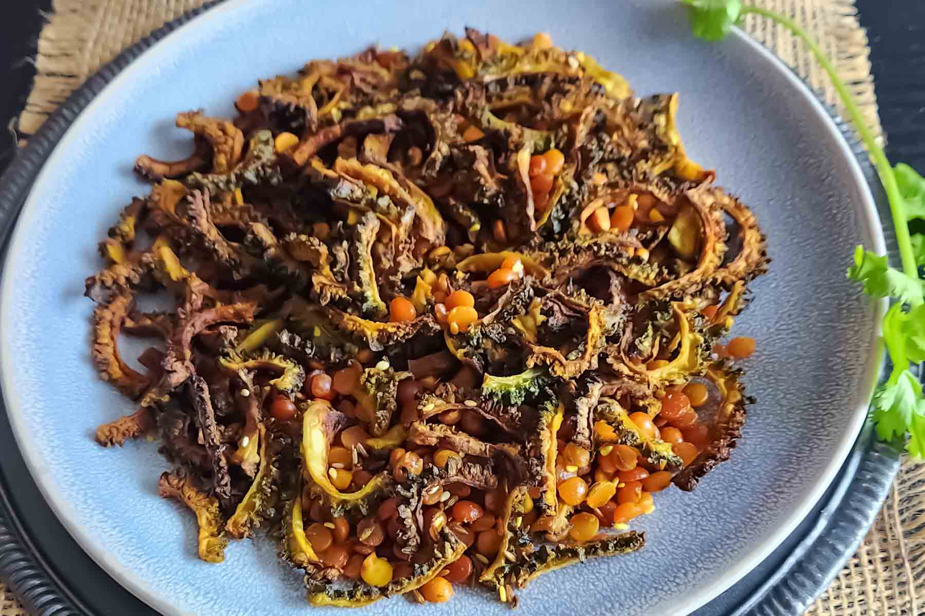 Indian-style crispy karela fry with chana dal and tadka spices.