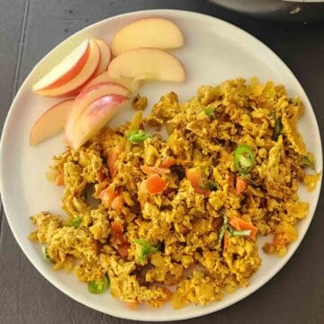 Homemade Anda Bhurji with soft scrambled eggs, tomato, onion, and green chilies. Egg bhurji is Indian Spiced Scrambled Eggs served for protein rich vegetarian breakfast.