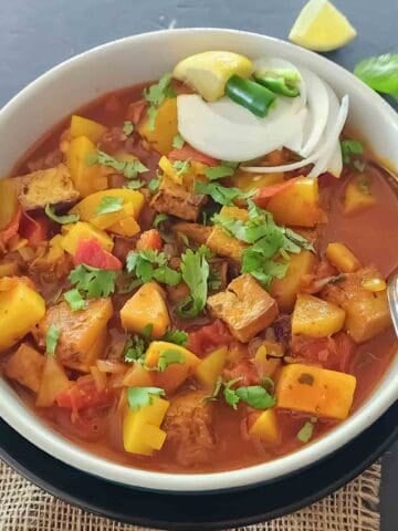 Easy Indian tofu curry recipe with potatoes, turmeric and garam masala for comforting meal full of plant protein.