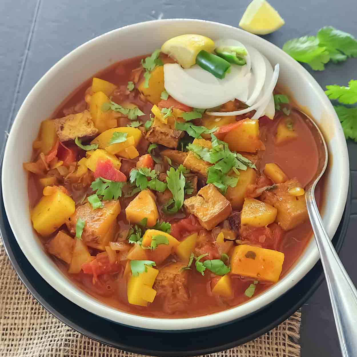 Easy Indian tofu curry recipe with potatoes, turmeric and garam masala for comforting meal full of plant protein.