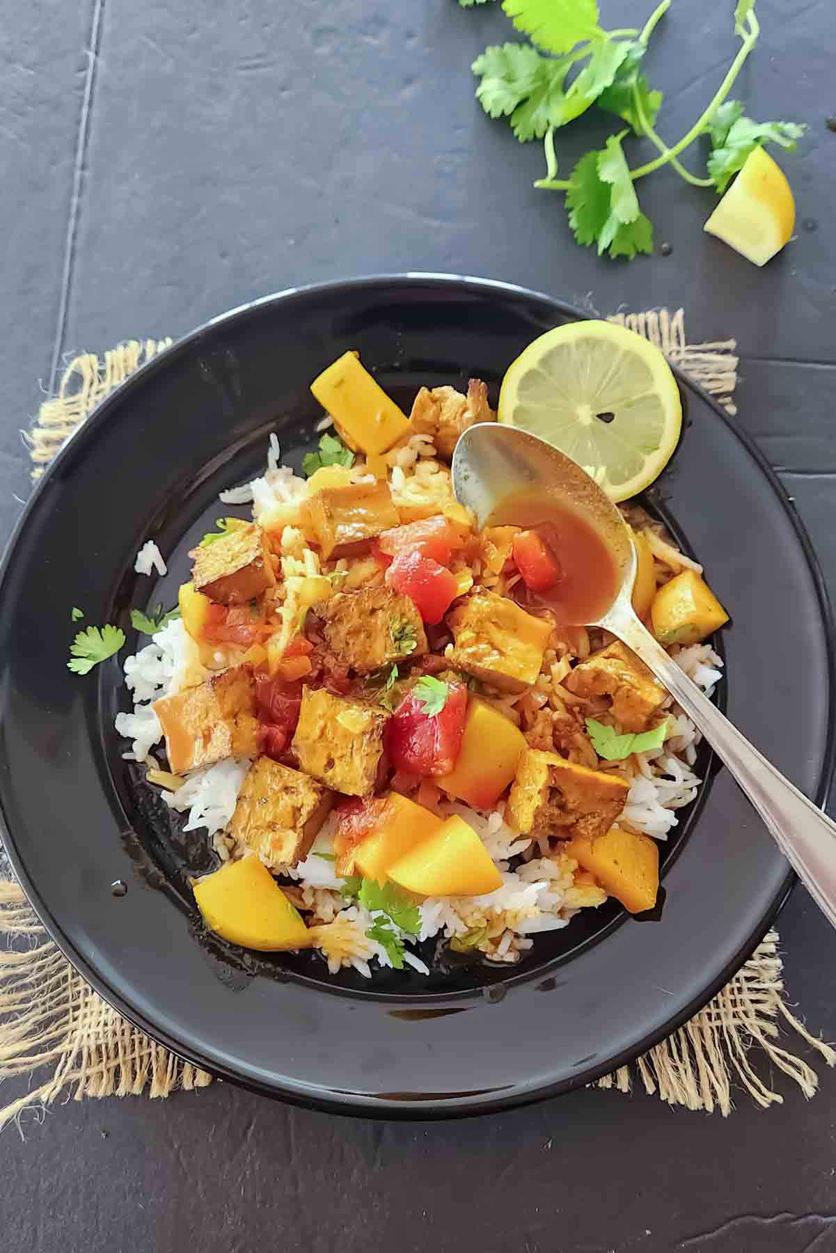 Vegan Indian tofu curry with tomato masala served over steamed basmati rice.