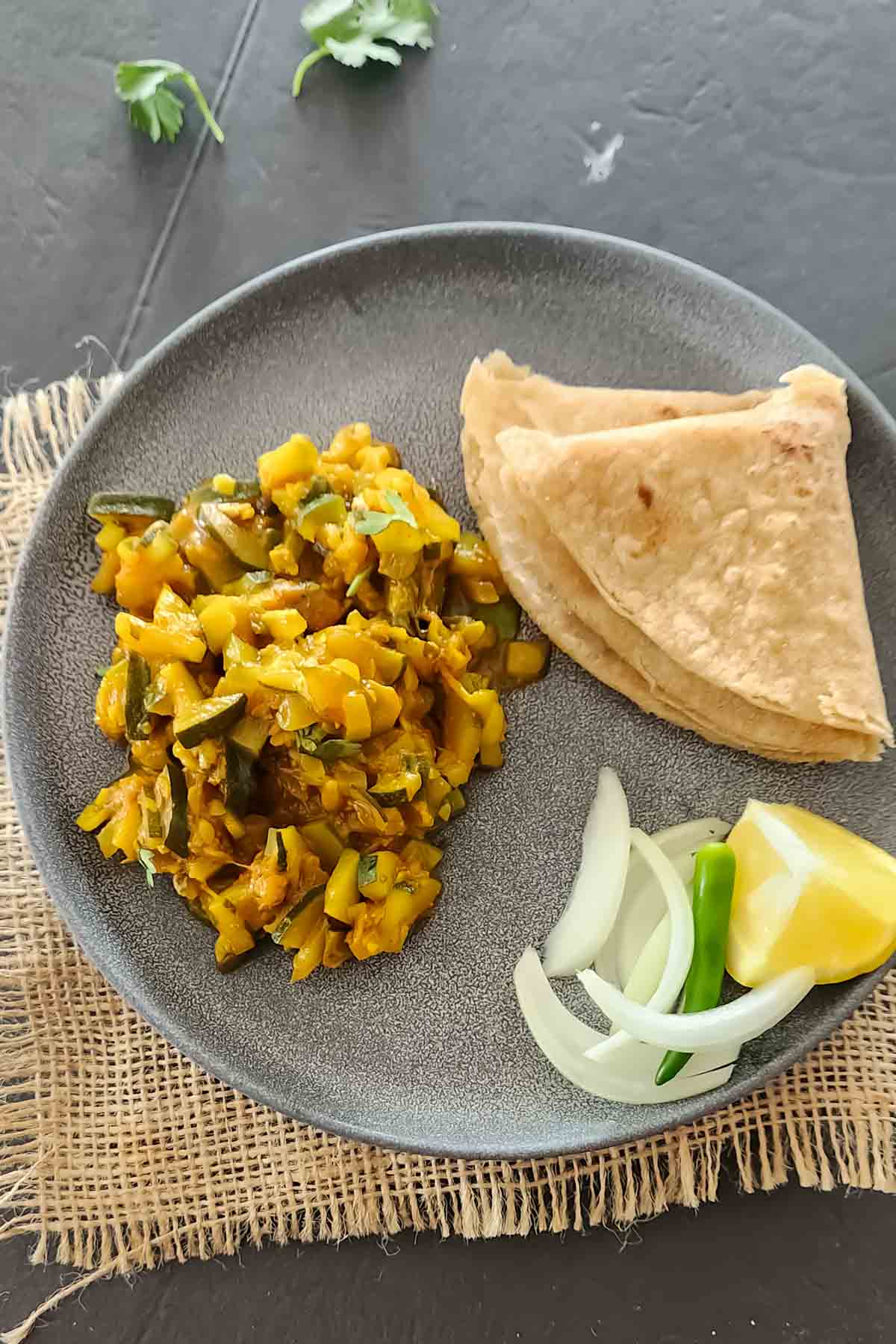 Healthy zucchini curry served with roti and onion salad.