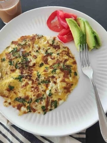 This easy Masala Omelette is a flavorful, high-protein Indian breakfast made with eggs, onions, green chili, cilantro, garam masala, and red chili powder. Ready in about 10 minutes!
