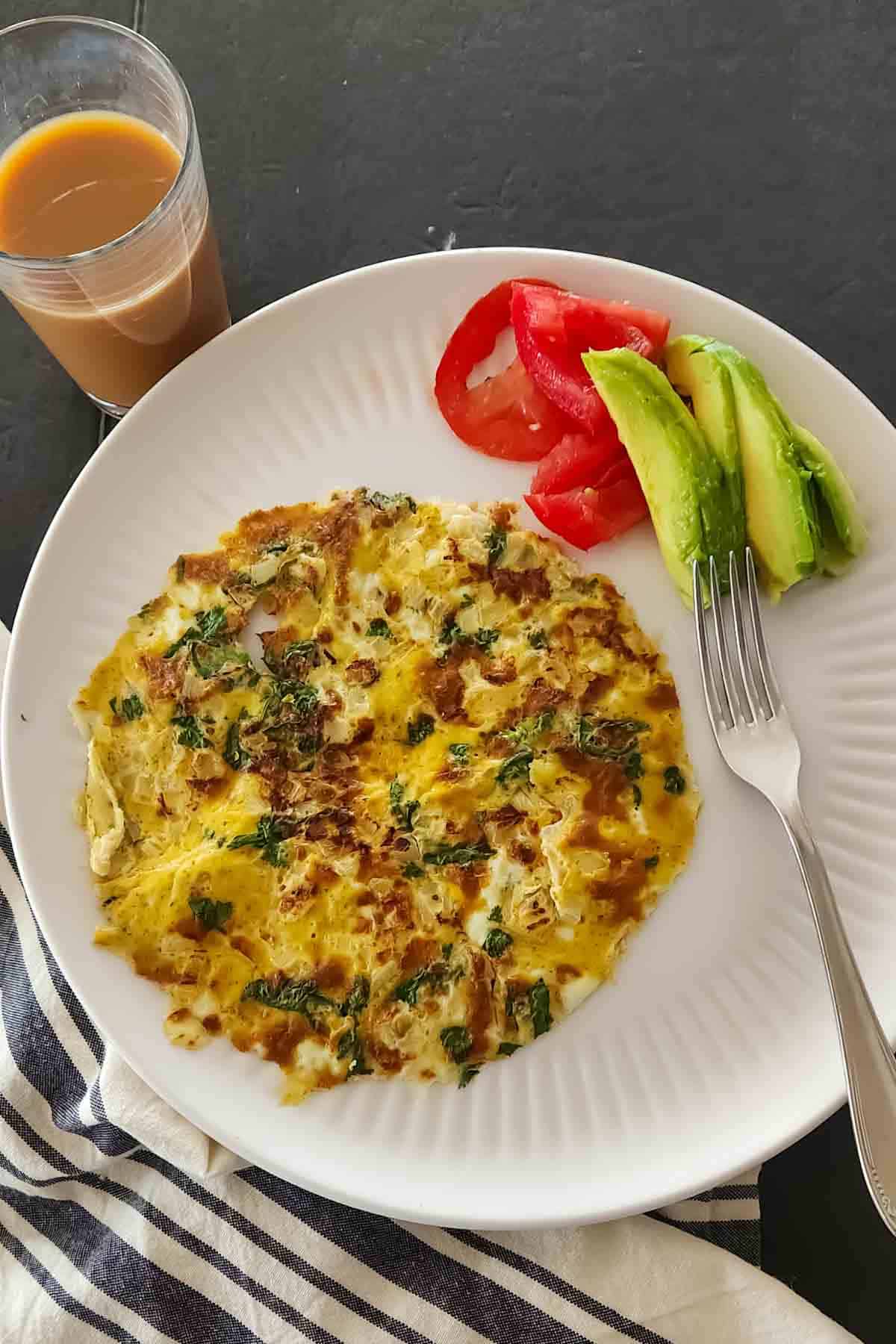 Indian masala omelette with onions and green chili, served for high-protein Indian vegetarian breakfast.