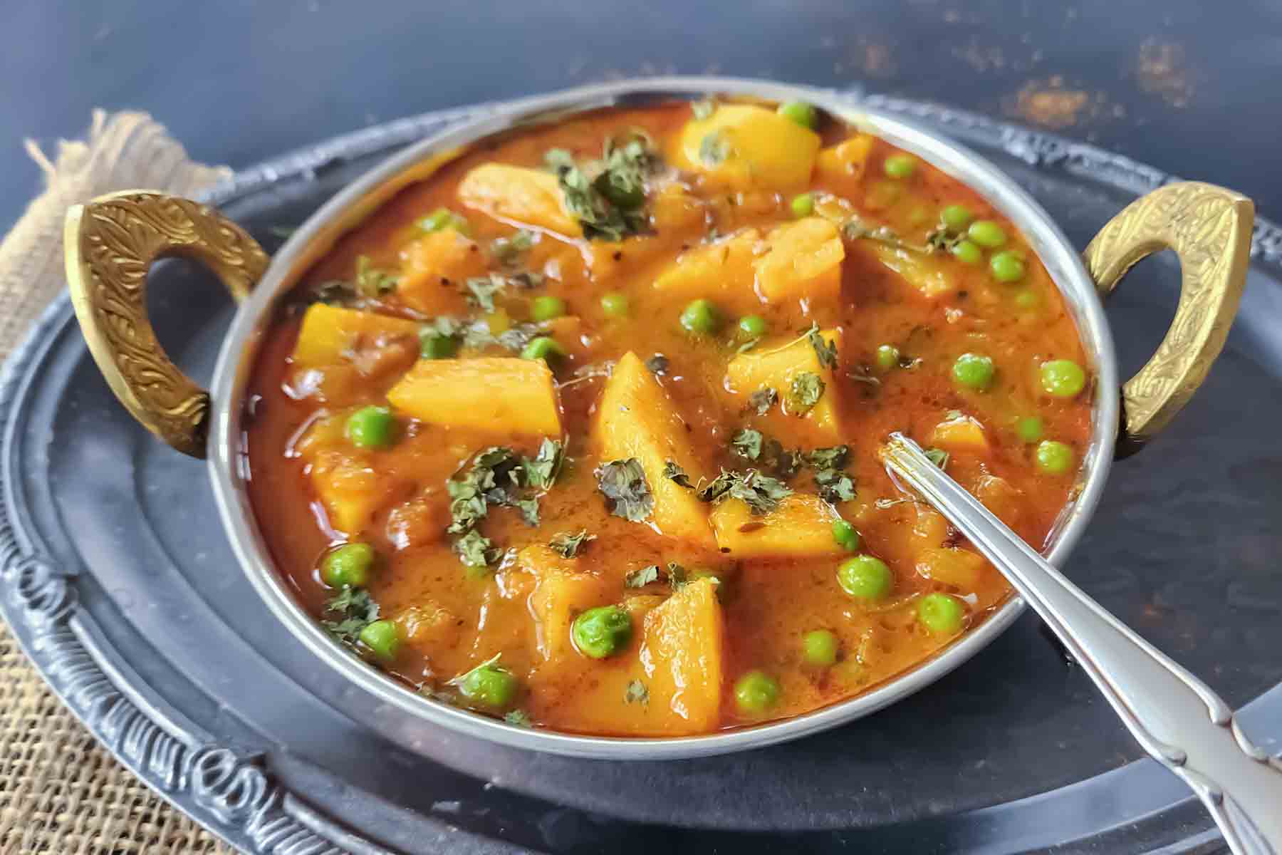 Homemade Indian potato curry served for hearty comforting vegan dinner.