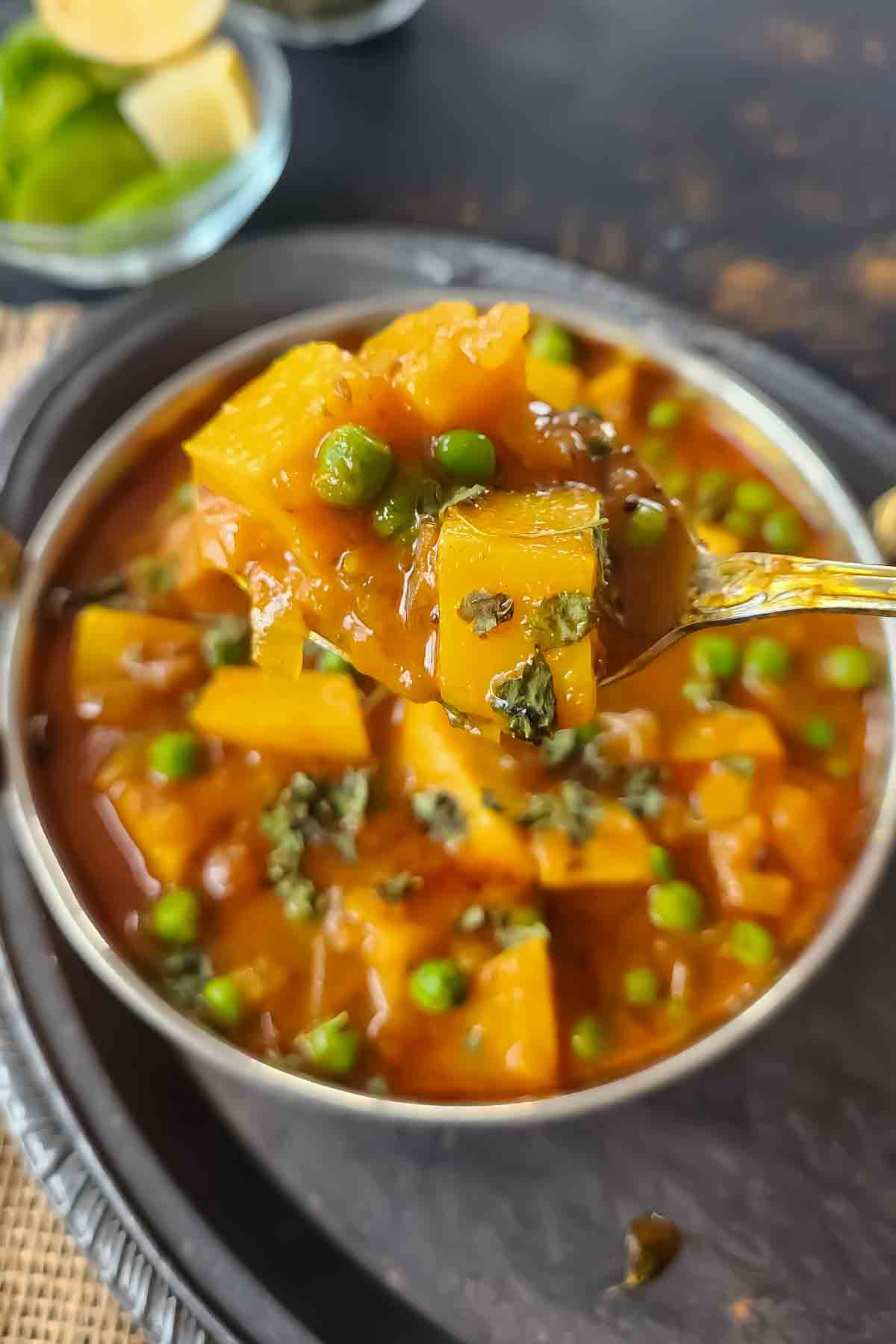 Close-up of tender potatoes simmered in a flavorful curry sauce.