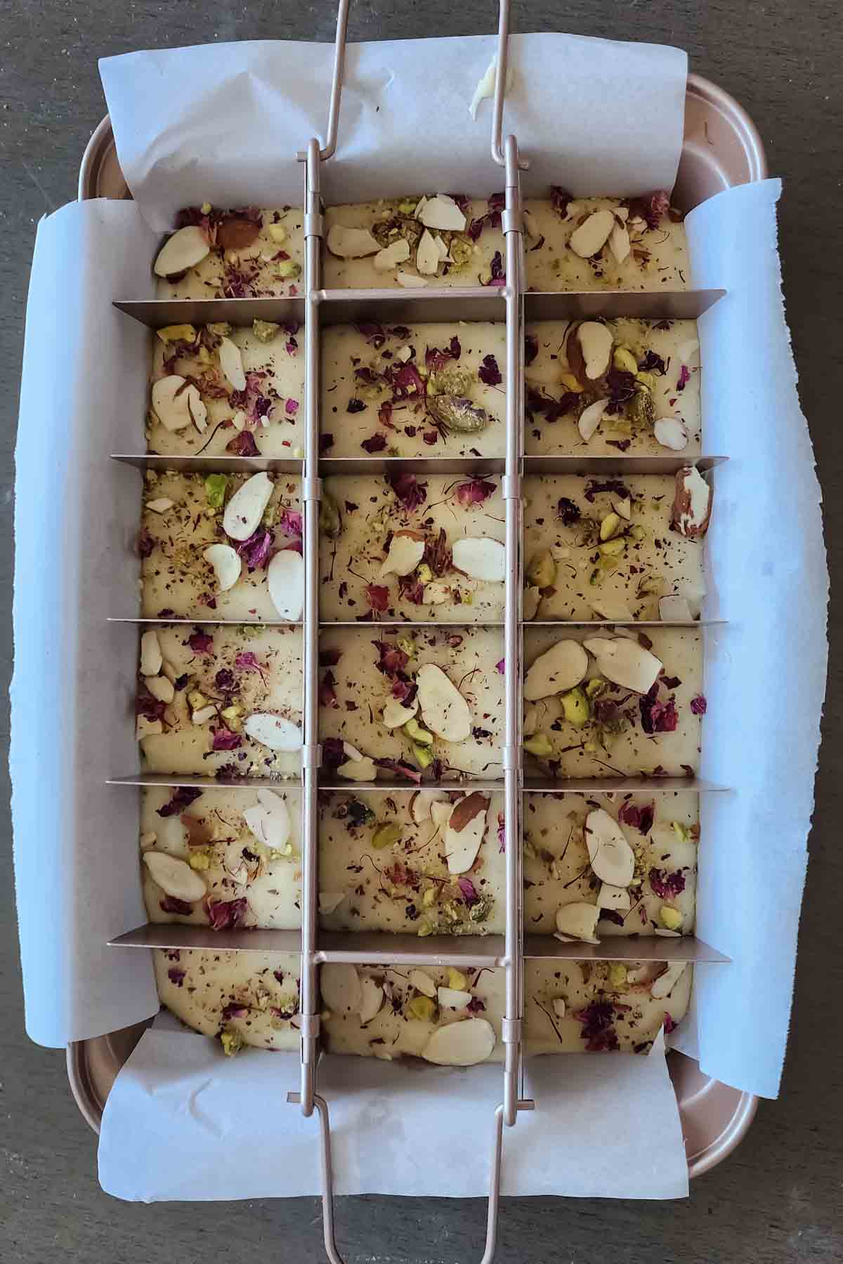 5 ingredient Indian white chocolate fudge with saffron and cardamom making in the fudge mould.