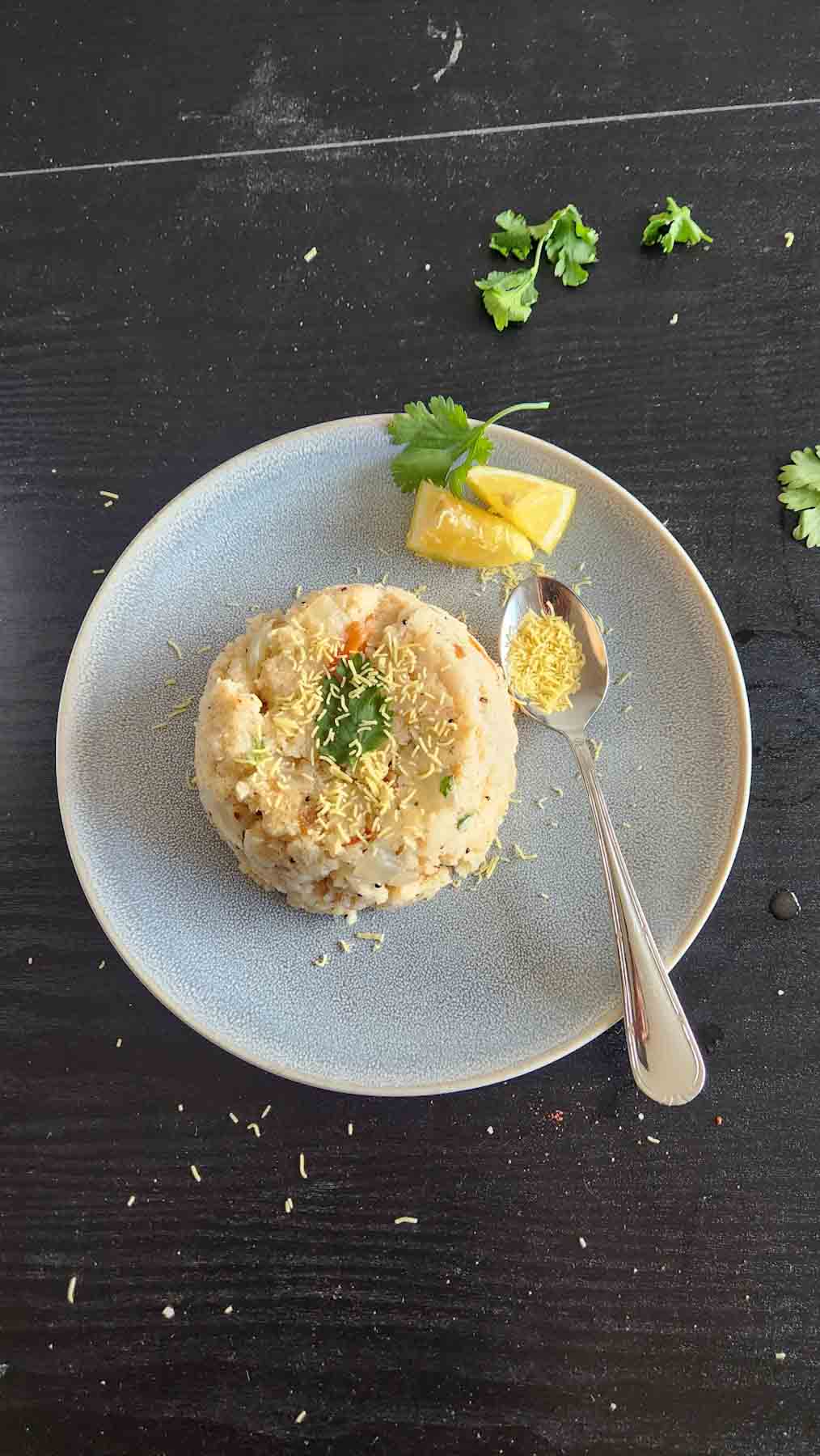 Indian spiced cream of wheat upma served with lemon, sev and fresh cilantro.