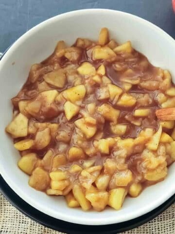 Homemade apple pie filling which is cinnamon apples made with fresh apple slices, sugar, and cinnamon for an easy breakfast topping.
