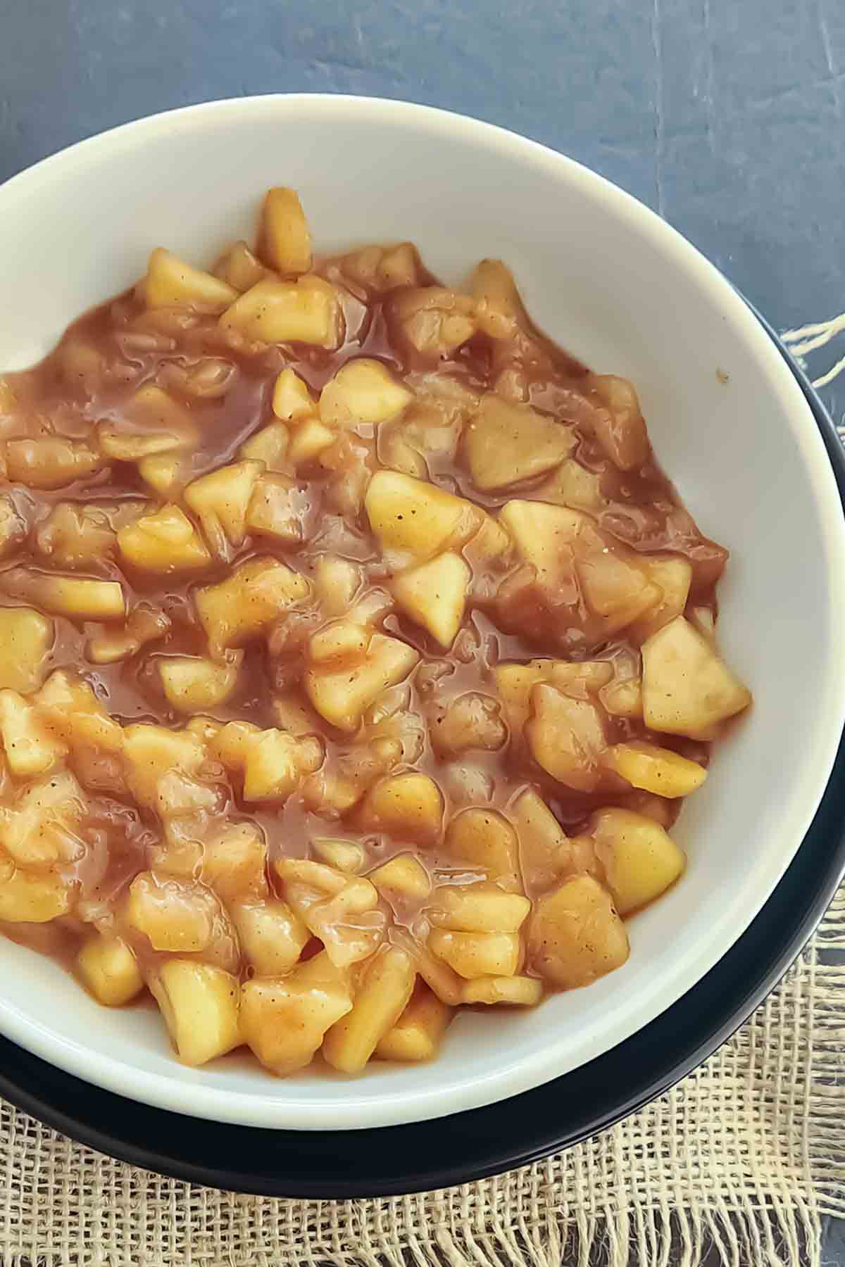 Easy cinnamon apples cooked with sugar and cinnamon in a thick, glossy sauce, perfect for fall desserts.