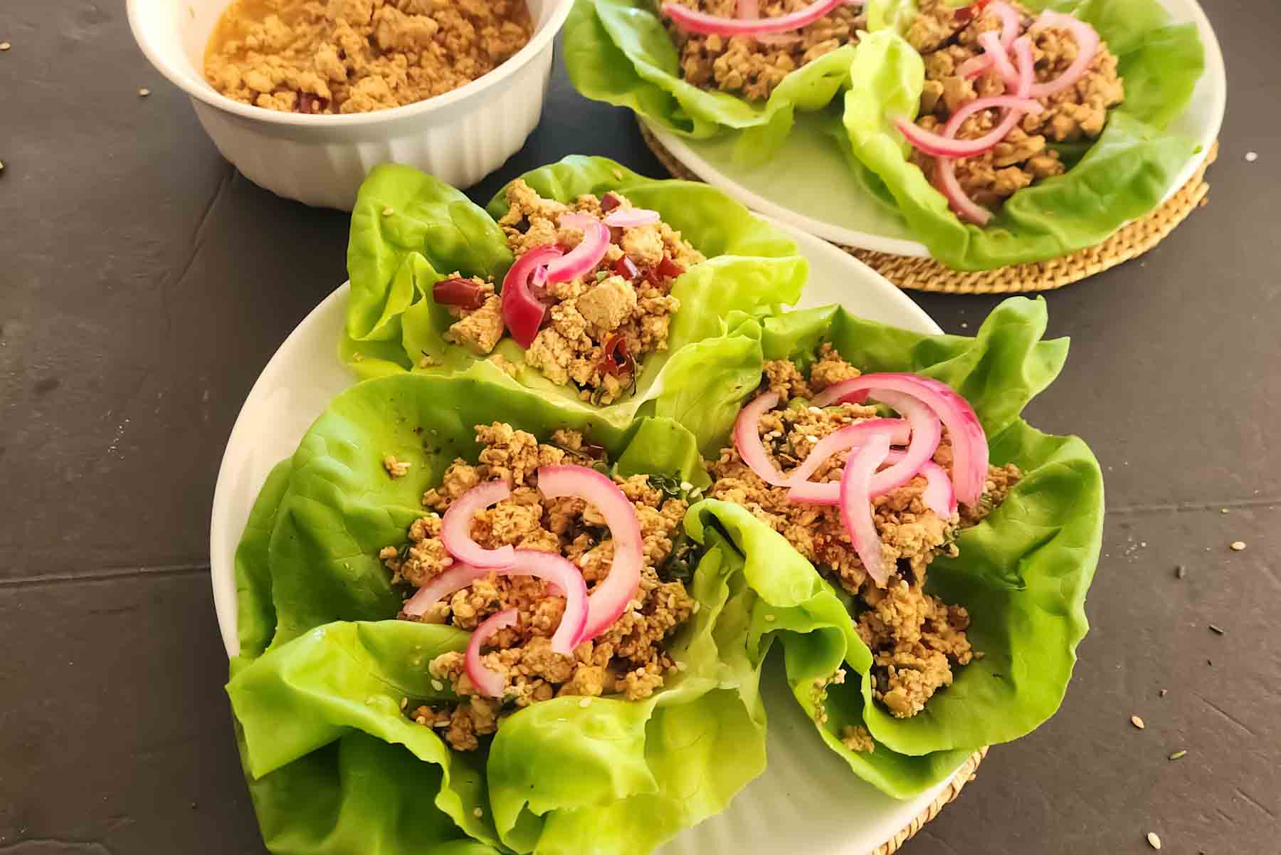 These vegan tofu lettuce wraps feature crumbled tofu tossed in a savory, spicy ginger miso sauce. Topped with pickled red onions and toasted sesame seeds, they're perfect for a quick lunch or easy tofu dinner.