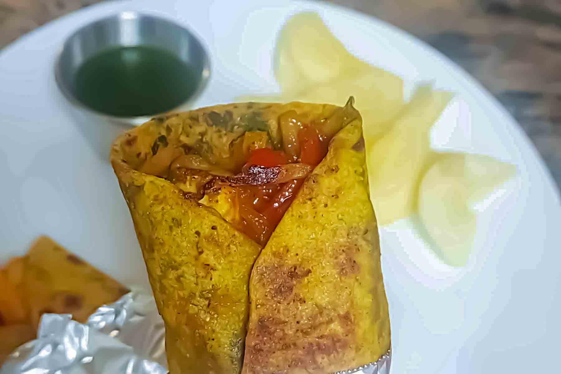 Paneer kathi roll filled with spiced paneer, sautéed onions, and bell peppers wrapped in Indian roti.