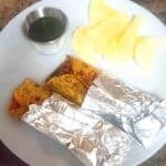 Paneer kathi roll filled with spiced paneer, sautéed onions, and bell peppers wrapped in Indian roti.