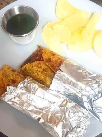 Paneer kathi roll filled with spiced paneer, sautéed onions, and bell peppers wrapped in Indian roti.
