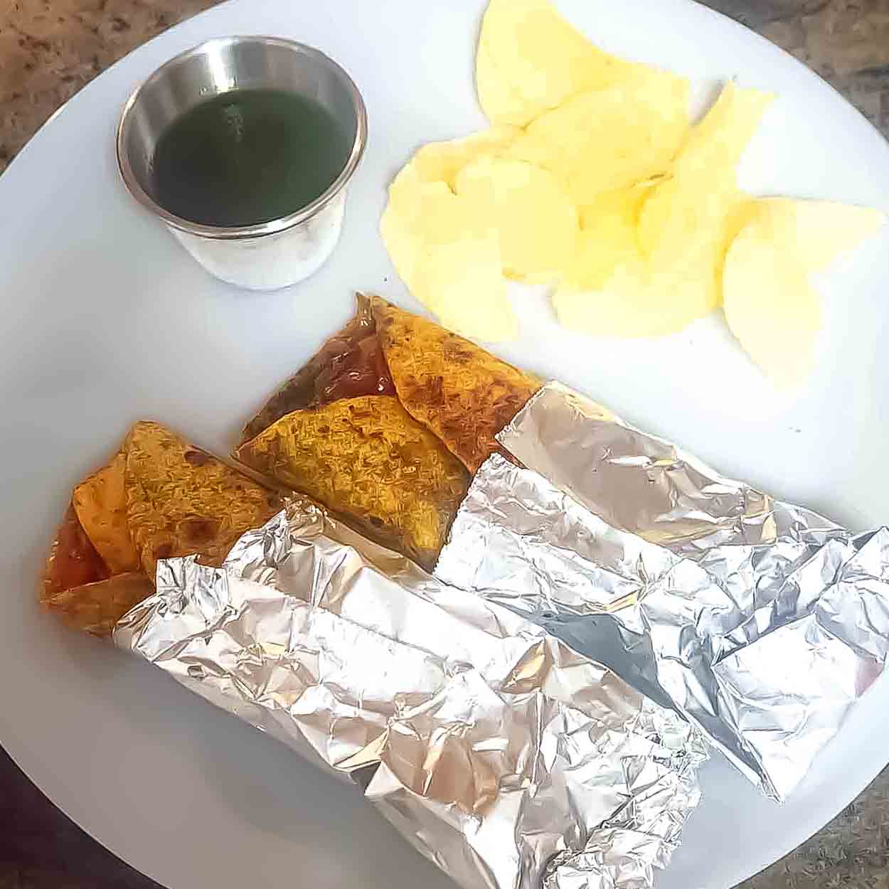 Paneer kathi roll filled with spiced paneer, sautéed onions, and bell peppers wrapped in Indian roti.