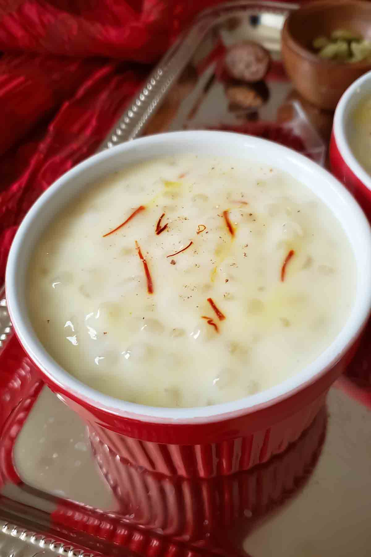 A bowl of creamy Indian sabudana kheer made with tapioca pearls, almond milk, cardamom, and saffron, served as an easy dairy-free Indian dessert.
