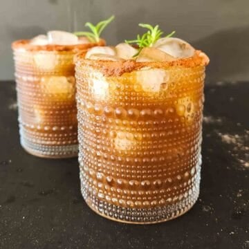 Tamarind mocktail recipe with ginger ale, ice, Indian chaat masala, and a Chamoy-rimmed glass.