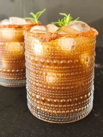 Tamarind mocktail recipe with ginger ale, ice, Indian chaat masala, and a Chamoy-rimmed glass.