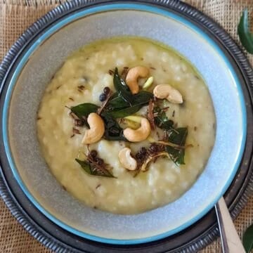 Ven Pongal is a traditional South Indian savory rice and moong dal dish seasoned with black pepper, cumin, ginger, curry leaves, and ghee. This easy Instant Pot Ven Pongal recipe makes a creamy, comforting vegetarian breakfast with simple pantry ingredients.
