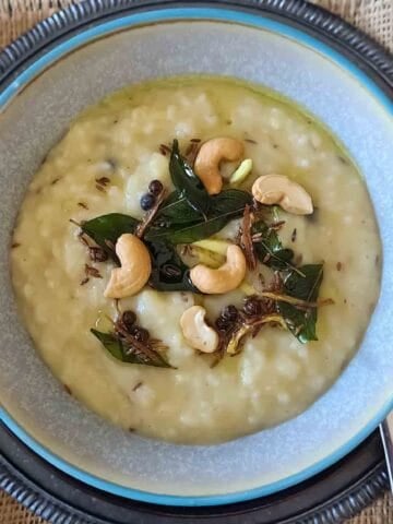 Ven Pongal is a traditional South Indian savory rice and moong dal dish seasoned with black pepper, cumin, ginger, curry leaves, and ghee. This easy Instant Pot Ven Pongal recipe makes a creamy, comforting vegetarian breakfast with simple pantry ingredients.